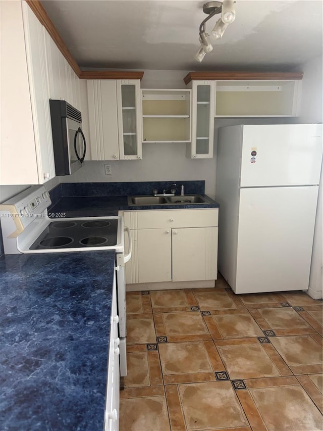 7850 Byron Ave Unit 403, Miami Beach, FL 33141 - kitchen with white appliances, open shelves, dark countertops, and glass insert cabinets