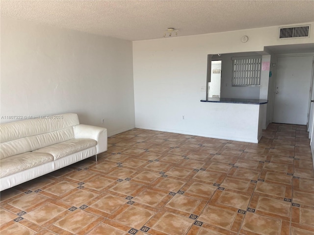7850 Byron Ave Unit 403, Miami Beach, FL 33141 - living area featuring a textured ceiling and baseboards