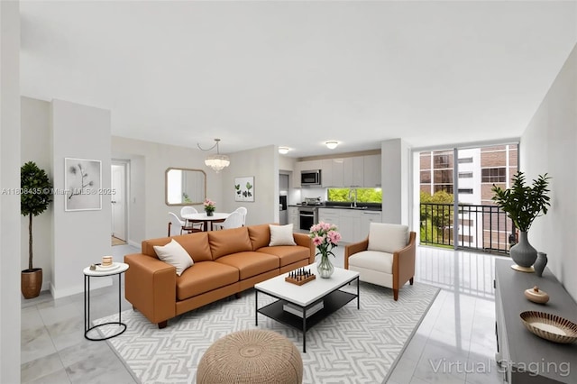 16919 N Bay Rd Unit 521, Sunny Isles Beach, FL 33160 - living room with a chandelier, light marble finish flooring, and baseboards