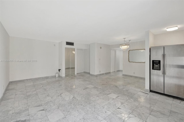 16919 N Bay Rd Unit 521, Sunny Isles Beach, FL 33160 - unfurnished living room featuring a chandelier, light marble finish flooring, and baseboards