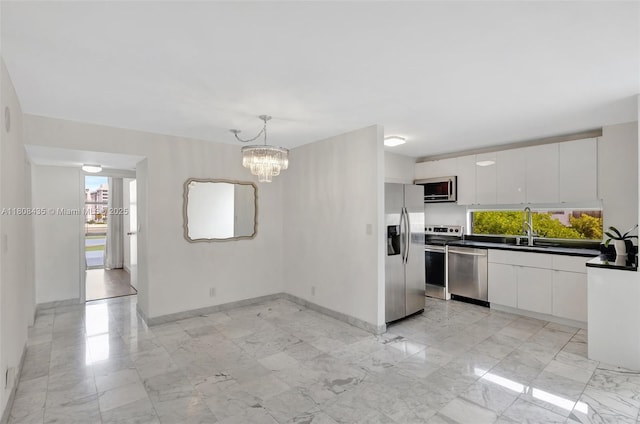 16919 N Bay Rd Unit 521, Sunny Isles Beach, FL 33160 - kitchen with appliances with stainless steel finishes, plenty of natural light, a sink, and light marble finish flooring
