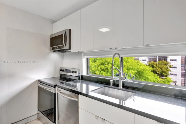 16919 N Bay Rd Unit 521, Sunny Isles Beach, FL 33160 - kitchen featuring stainless steel appliances, a sink, white cabinetry, and modern cabinets