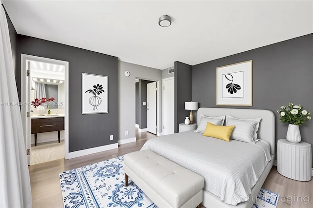 16919 N Bay Rd Unit 521, Sunny Isles Beach, FL 33160 - bedroom featuring wood finished floors, baseboards, and connected bathroom
