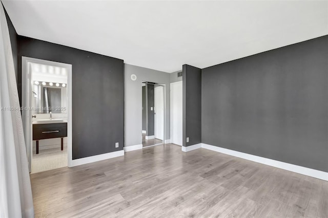 16919 N Bay Rd Unit 521, Sunny Isles Beach, FL 33160 - empty room with wood finished floors, a sink, and baseboards