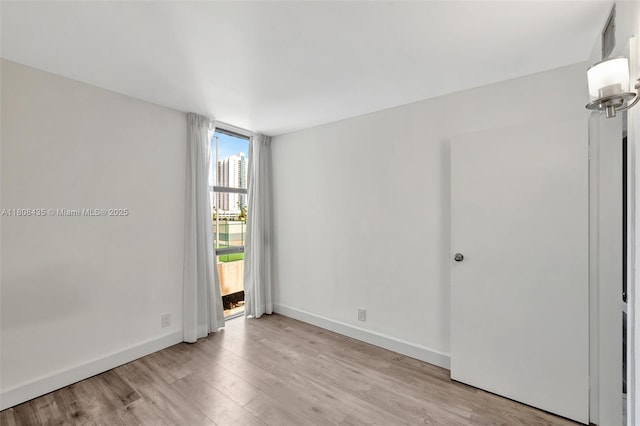 16919 N Bay Rd Unit 521, Sunny Isles Beach, FL 33160 - spare room featuring light wood-style flooring and baseboards