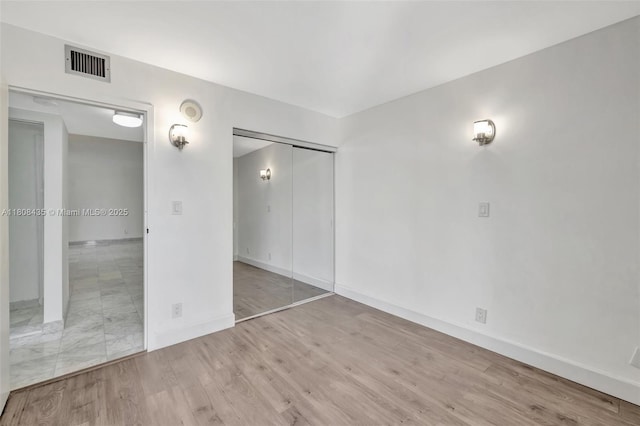 16919 N Bay Rd Unit 521, Sunny Isles Beach, FL 33160 - unfurnished bedroom with wood finished floors and baseboards