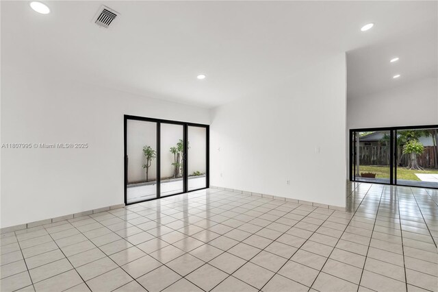 14234 SW 49th St, Miami, FL 33175 - spare room featuring light tile patterned floors, recessed lighting, baseboards, and a high ceiling