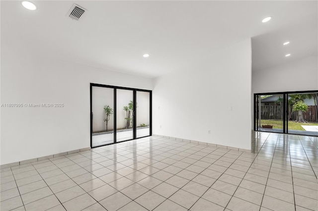 14234 SW 49th St, Miami, FL 33175 - empty room with light tile patterned floors, recessed lighting, baseboards, and a high ceiling