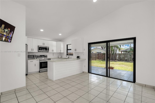 14234 SW 49th St, Miami, FL 33175 - kitchen with stainless steel appliances, a peninsula, a sink, white cabinets, and light countertops