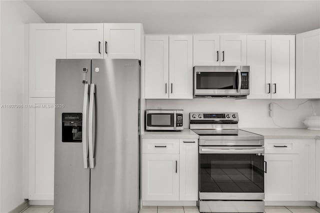 14234 SW 49th St, Miami, FL 33175 - kitchen with appliances with stainless steel finishes, light countertops, white cabinetry, and light tile patterned floors