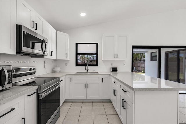14234 SW 49th St, Miami, FL 33175 - kitchen with appliances with stainless steel finishes, a sink, a peninsula, light countertops, and white cabinetry
