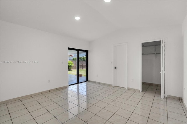 14234 SW 49th St, Miami, FL 33175 - unfurnished bedroom with access to exterior, vaulted ceiling, a walk in closet, recessed lighting, and light tile patterned floors