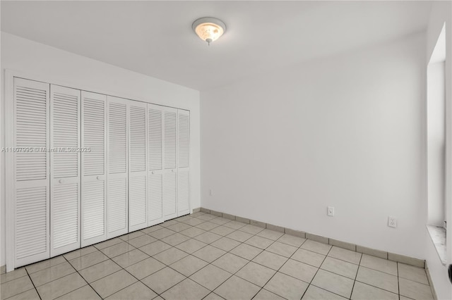14234 SW 49th St, Miami, FL 33175 - unfurnished bedroom with light tile patterned floors and a closet