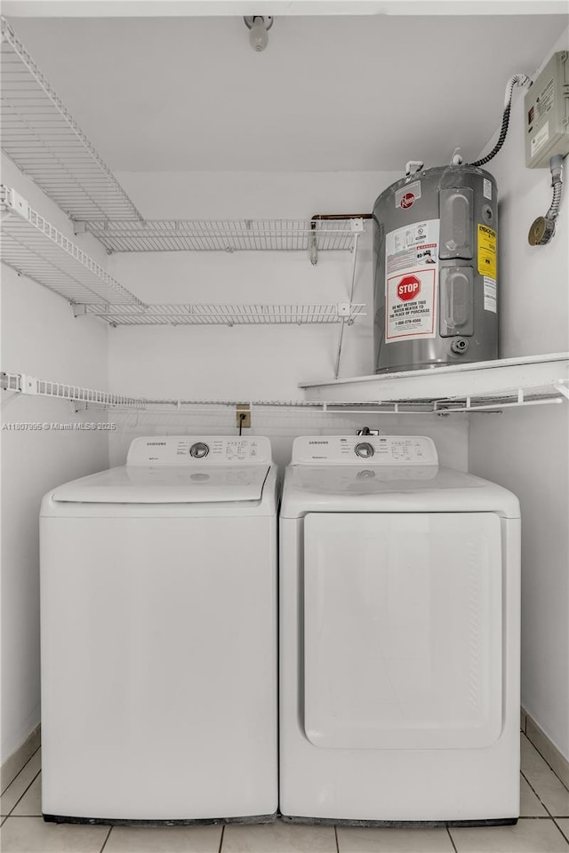 14234 SW 49th St, Miami, FL 33175 - laundry area featuring washer and dryer, light tile patterned floors, and baseboards