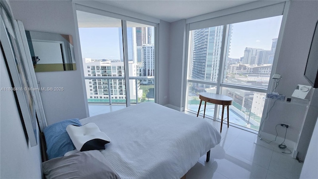 480 NE 30th St Unit 1405, Miami, FL 33137 - bedroom featuring a city view, multiple windows, and tile patterned floors