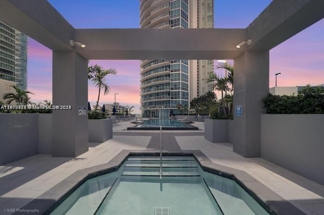 480 NE 30th St Unit 1405, Miami, FL 33137 - pool at dusk with a community pool and a patio area