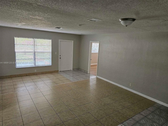 3773 NW 1st Ct, Lauderhill, FL 33311 - tiled spare room featuring a textured ceiling and baseboards