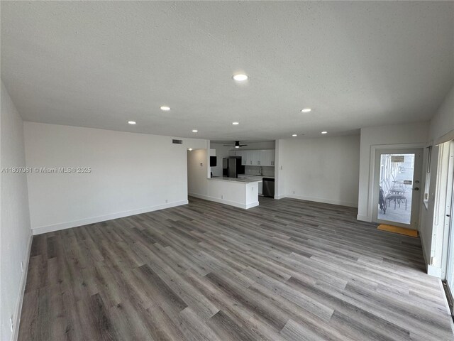 630 Layne Blvd Unit 211, Hallandale Beach, FL 33009 - unfurnished living room with recessed lighting, wood finished floors, a ceiling fan, and a textured ceiling