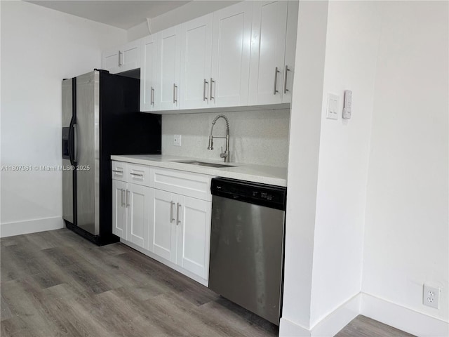 630 Layne Blvd Unit 211, Hallandale Beach, FL 33009 - kitchen with stainless steel appliances, a sink, light countertops, white cabinetry, and backsplash
