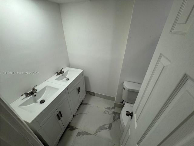 630 Layne Blvd Unit 211, Hallandale Beach, FL 33009 - bathroom featuring marble finish flooring, toilet, double vanity, and baseboards