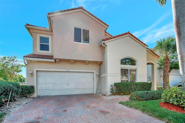 1874 NW 74th Way, Pembroke Pines, FL 33024 - mediterranean / spanish-style home featuring a tile roof, stucco siding, a garage, and decorative driveway