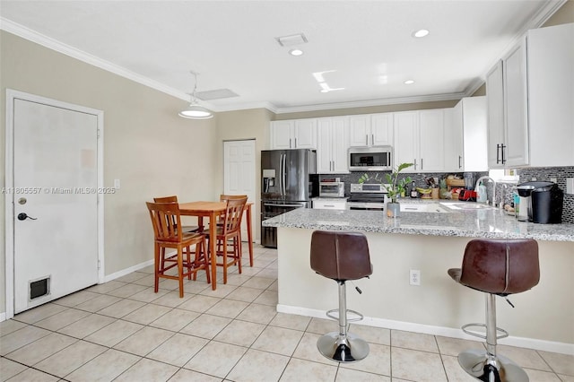 1874 NW 74th Way, Pembroke Pines, FL 33024 - kitchen featuring stainless steel appliances, a sink, a peninsula, ornamental molding, and light tile patterned flooring