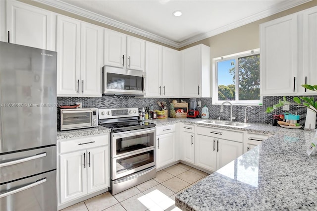 1874 NW 74th Way, Pembroke Pines, FL 33024 - kitchen featuring stainless steel appliances, a sink, white cabinets, light tile patterned floors, and tasteful backsplash