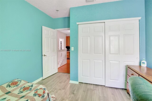 1874 NW 74th Way, Pembroke Pines, FL 33024 - bedroom featuring light wood-style flooring, a closet, and baseboards