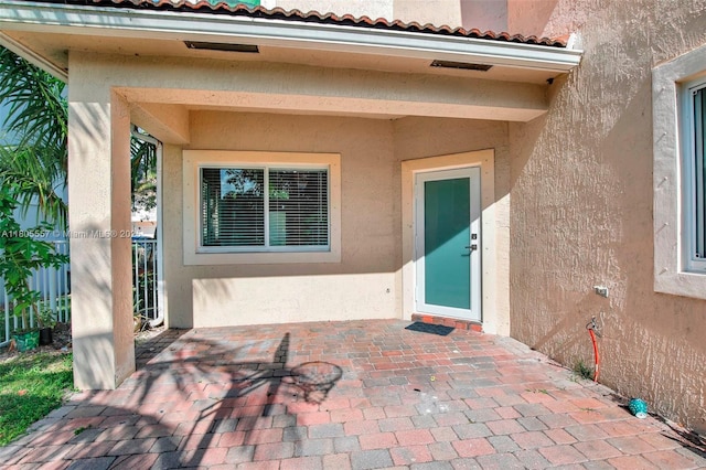 1874 NW 74th Way, Pembroke Pines, FL 33024 - doorway to property featuring stucco siding and a patio