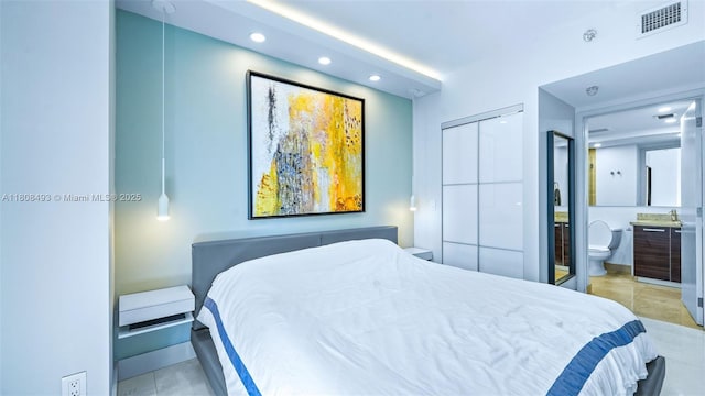 185 SW 7th St Unit 2911, Miami, FL 33130 - bedroom featuring recessed lighting, ensuite bathroom, light tile patterned floors, and a closet