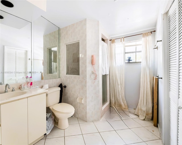 11351 SW 52nd Ter, Miami, FL 33165 - bathroom with toilet, vanity, tile patterned flooring, tile walls, and a stall shower