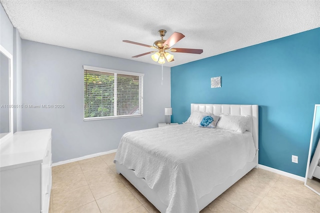 821 NW 91st Ter Unit 821, Plantation, FL 33324 - bedroom with a textured ceiling, light tile patterned floors, baseboards, and ceiling fan