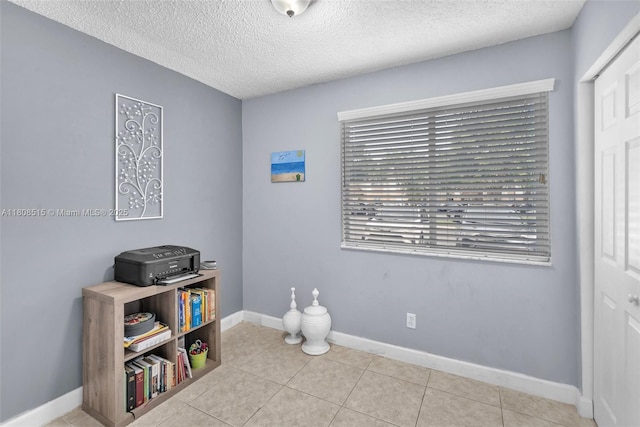 821 NW 91st Ter Unit 821, Plantation, FL 33324 - bedroom with a textured ceiling, baseboards, and tile patterned floors