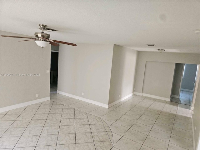 5960 NW 14th St, Sunrise, FL 33313 - spare room with light tile patterned floors, a textured ceiling, ceiling fan, and baseboards