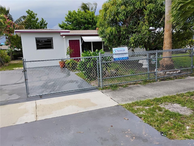 3161 NW 5th St, Lauderhill, FL 33311 - view of front of house featuring a fenced front yard, stucco siding, and a gate