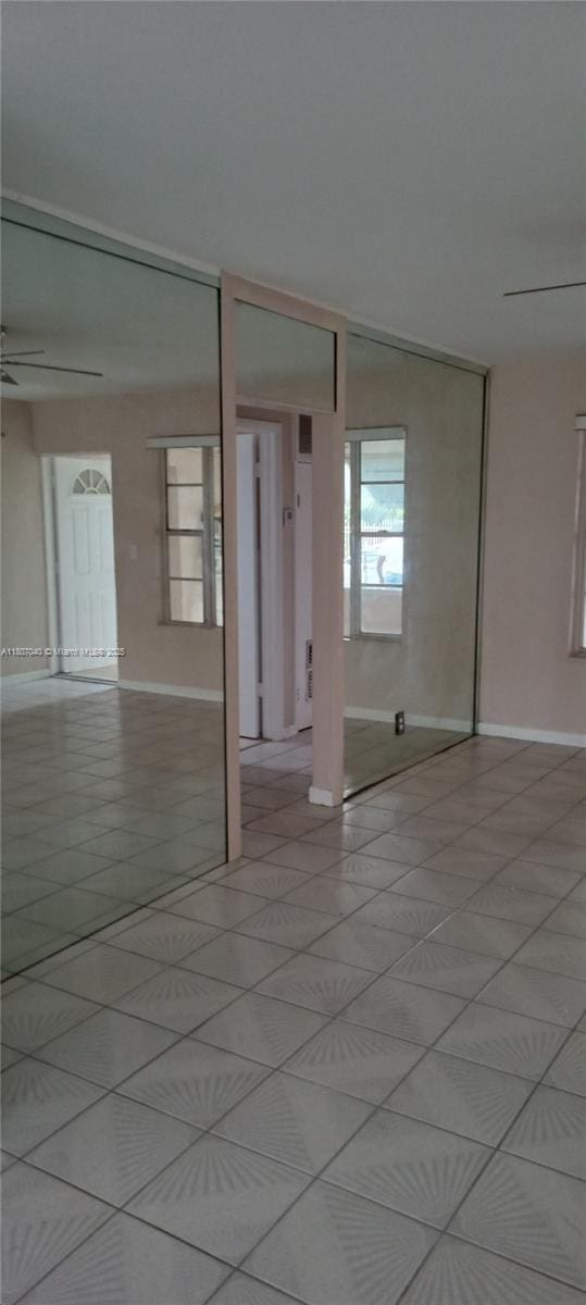3161 NW 5th St, Lauderhill, FL 33311 - empty room featuring baseboards, light tile patterned floors, and a ceiling fan