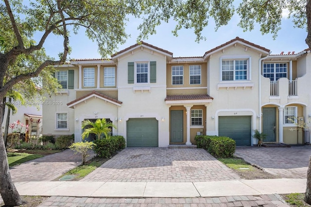 623 NE 21st Ter, Homestead, FL 33033 - townhome / multi-family property with a tile roof, driveway, a garage, and stucco siding