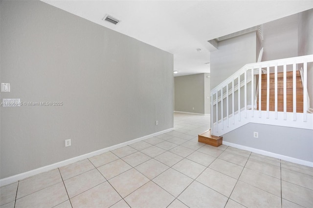 623 NE 21st Ter, Homestead, FL 33033 - unfurnished room with stairs, tile patterned floors, and baseboards
