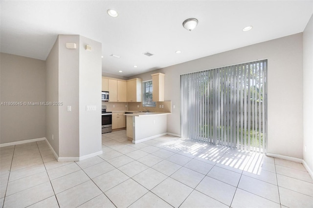 623 NE 21st Ter, Homestead, FL 33033 - kitchen featuring light countertops, appliances with stainless steel finishes, light brown cabinetry, open floor plan, and light tile patterned floors