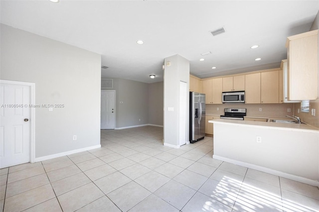 623 NE 21st Ter, Homestead, FL 33033 - kitchen featuring stainless steel appliances, a sink, light countertops, light brown cabinetry, and light tile patterned flooring