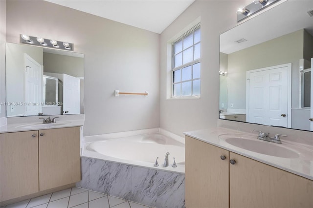 623 NE 21st Ter, Homestead, FL 33033 - bathroom featuring two vanities, a bath, tile patterned flooring, and a stall shower