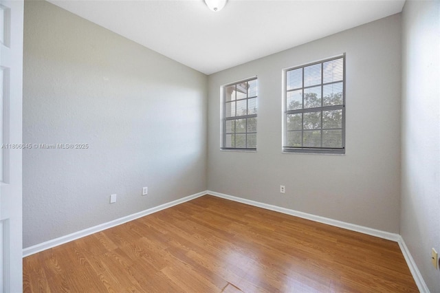 623 NE 21st Ter, Homestead, FL 33033 - empty room featuring wood finished floors and baseboards