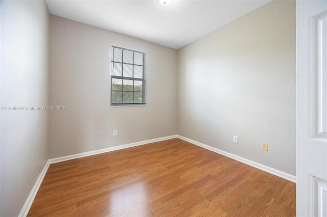 623 NE 21st Ter, Homestead, FL 33033 - spare room featuring wood finished floors and baseboards
