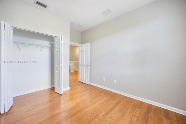 623 NE 21st Ter, Homestead, FL 33033 - unfurnished bedroom with light wood finished floors, a closet, and baseboards
