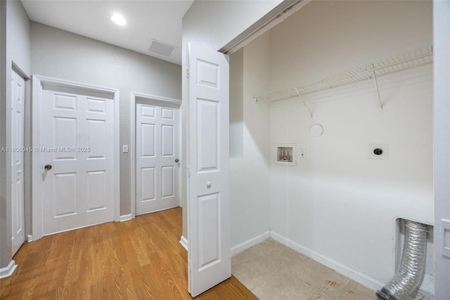 623 NE 21st Ter, Homestead, FL 33033 - laundry area with hookup for an electric dryer, hookup for a washing machine, baseboards, and light wood finished floors