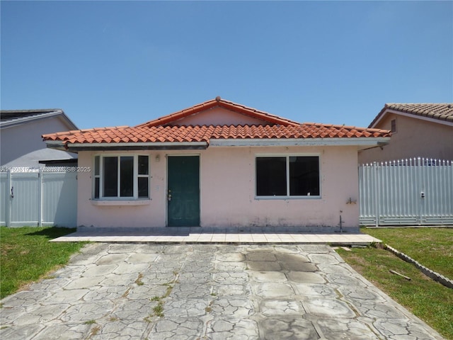 9023 NW 113th St, Hialeah Gardens, FL 33018 - view of front facade featuring a tiled roof, a patio area, stucco siding, and a gate