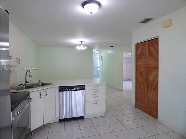9023 NW 113th St, Hialeah Gardens, FL 33018 - kitchen with appliances with stainless steel finishes, a sink, white cabinetry, light countertops, and a peninsula