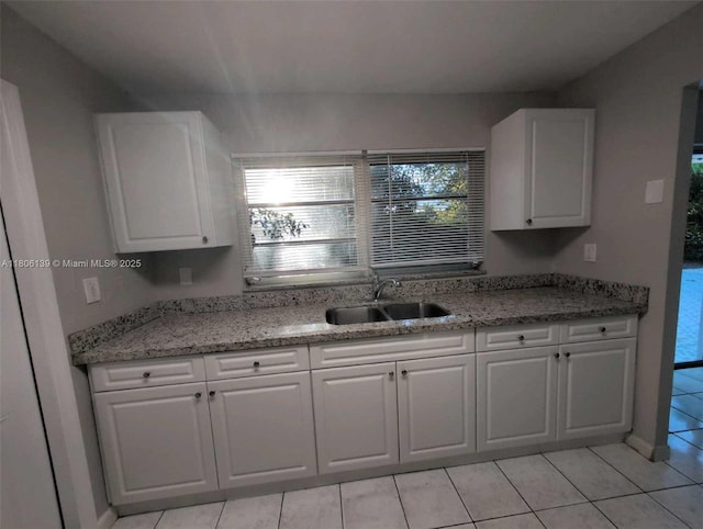 7911 SW 132nd Ave, Miami, FL 33183 - kitchen featuring a sink, light tile patterned floors, white cabinets, and light stone countertops