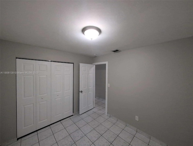 7911 SW 132nd Ave, Miami, FL 33183 - unfurnished bedroom featuring a closet, light tile patterned flooring, and baseboards