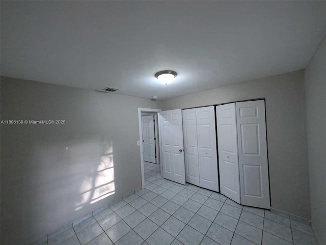 7911 SW 132nd Ave, Miami, FL 33183 - unfurnished bedroom featuring light tile patterned flooring, a closet, and baseboards